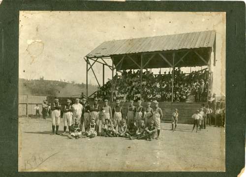 Early Base Ball Team with Suspenders on Uniforms on Field in Front of Stands 1896